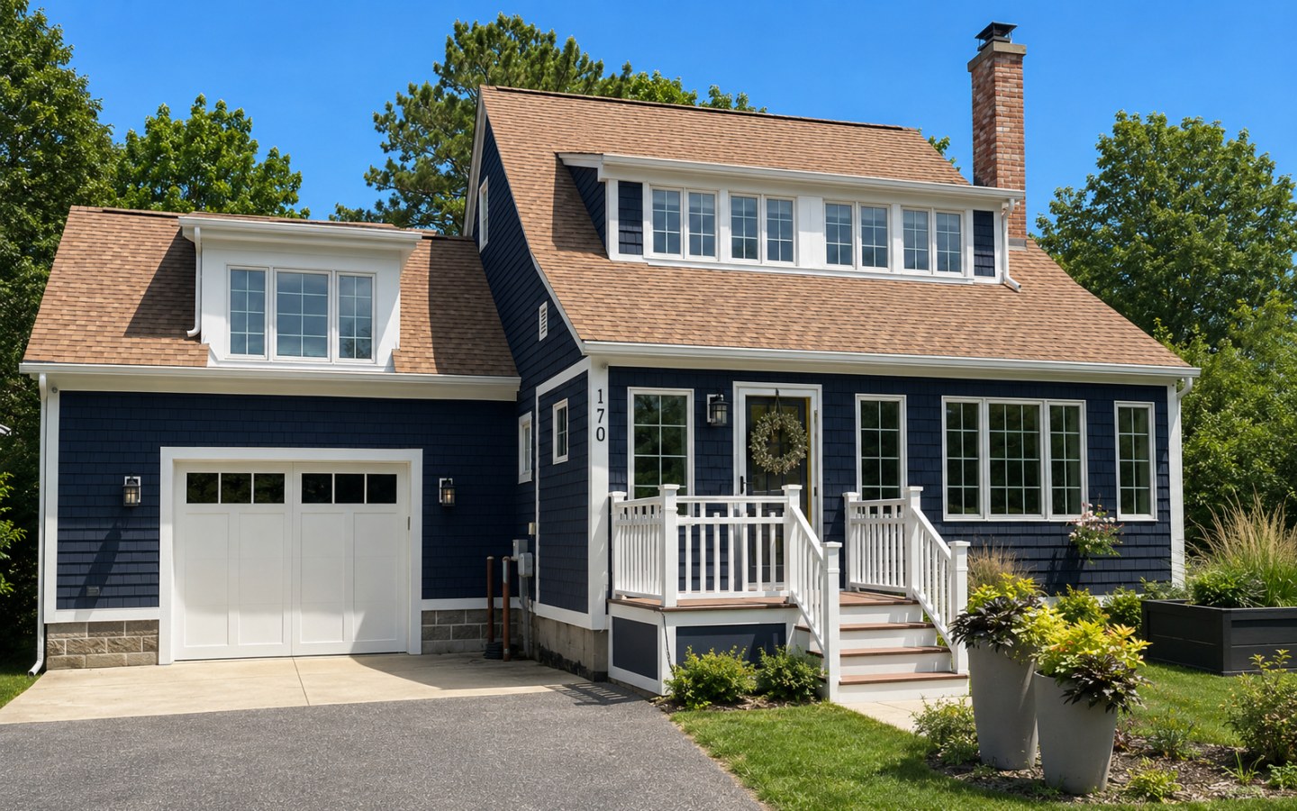 After: full exterior repainted in deep navy with fresh white trim